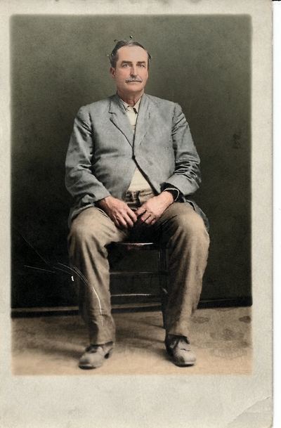 Restored and colorized (AI-assisted); colours are a best guess. David Emily Coffman, seated studio portrait.