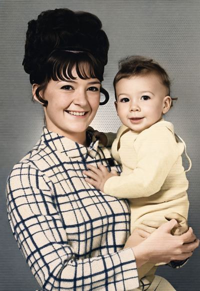 Restored and colorized with AI from the original, c. 1967. Colours are a best guess. Nancy Proeger holding her infant son Earl, c. 1967.