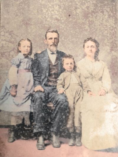 Restored and colorized (AI-assisted); faces are the original photo, colours are a best guess. David B. and Sue Martin with their children, including Ella and Clarence.