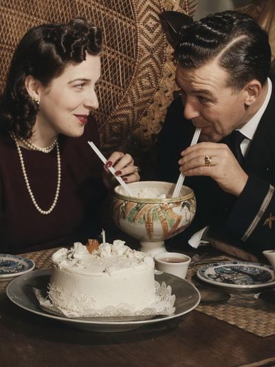 Restored and colorized with AI from the original, c. 1940s-1950s. Colours are a best guess. Aileane Marie Silva and Earl T. Roberts at a cake table.